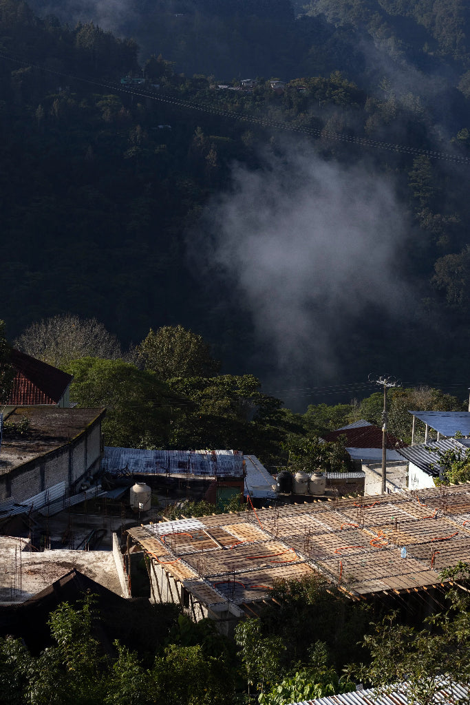 Village with houses and roofs in a mountainous area with mist