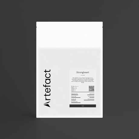 White coffee bag with black text and 'Artefact' branding on a dark background